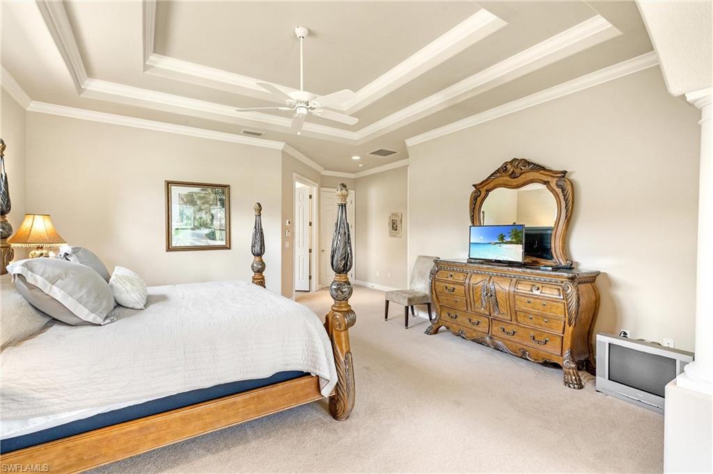 Recessed ceiling featuring decorative trim and a ceiling fan