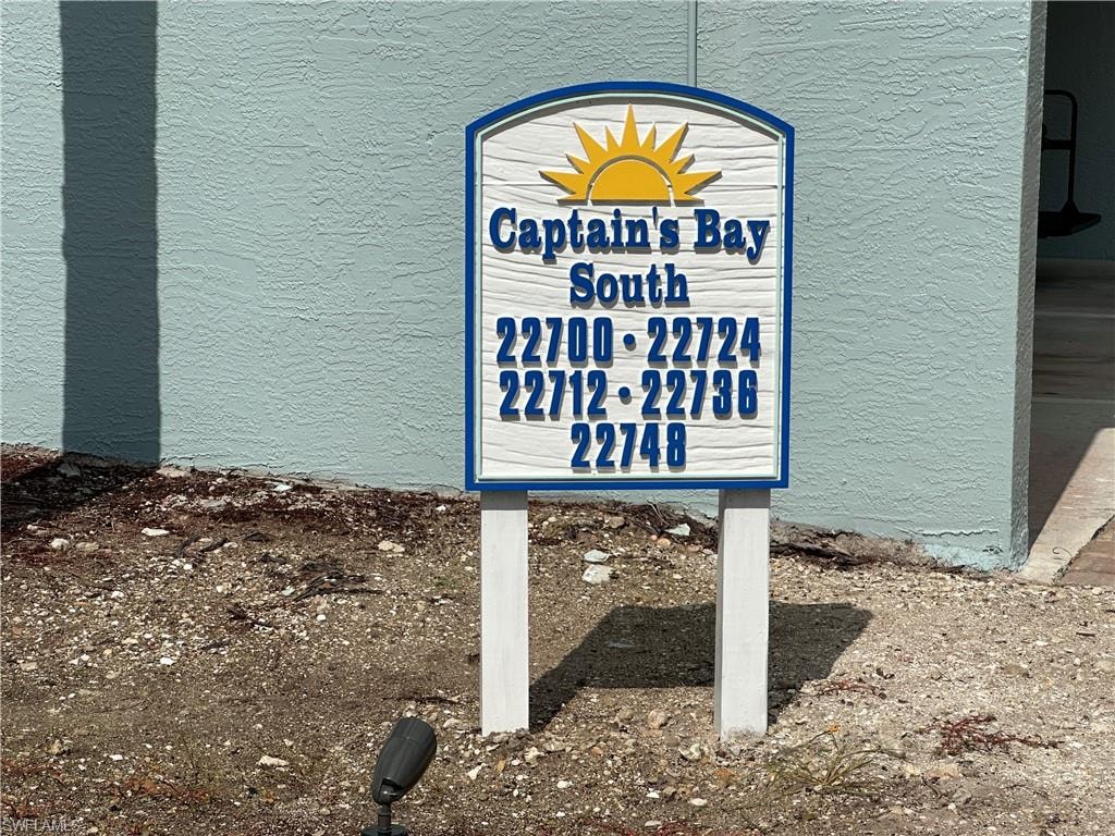 Captain's Bay South directional signage featuring white and blue detailing with a prominent sun graphic