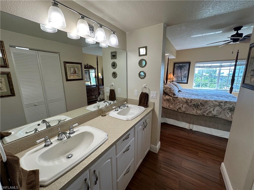 Dual vanity with white cabinetry, polished chrome fixtures, and a spacious countertop