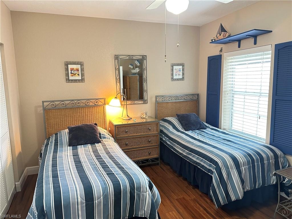 Room featuring wood-finish flooring and a ceiling fan