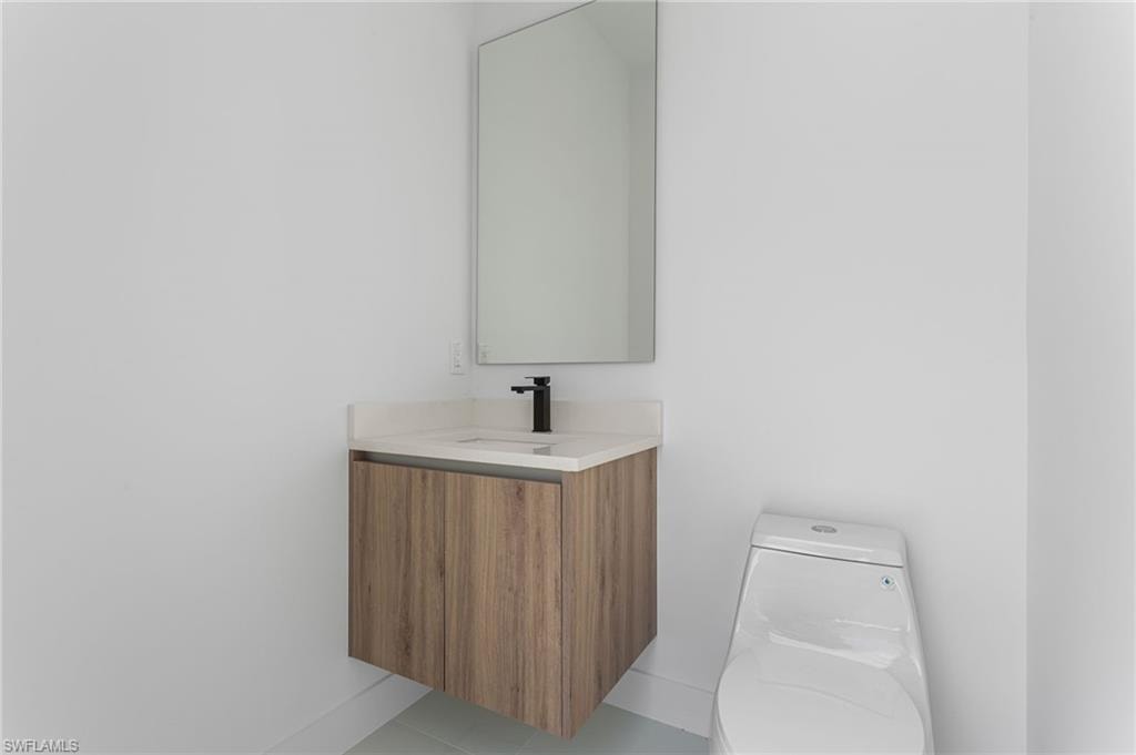 Cabana pool bathroom with A/C, sink, mirror,and toilet - no need to get into the home!