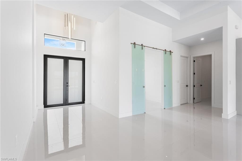 Enter through the COVERED FRONT PORCH andGRAND DOUBLE DOORS into a SOARING 16-FTFOYER, where a NEUTRAL PALETTE OF WHITE,LIGHT GRAY, and CASHMERE WELCOMES YOUHOME!