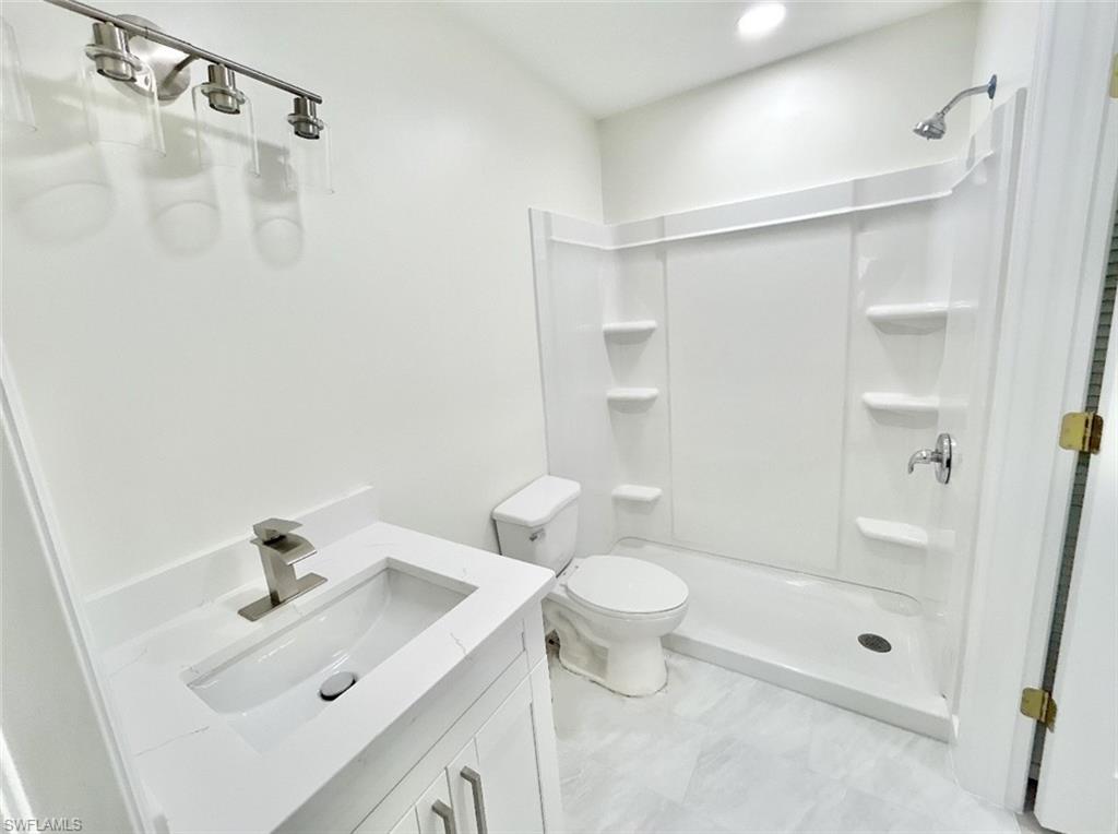 Bathroom with dual vanities, dual sinks, and shower.
