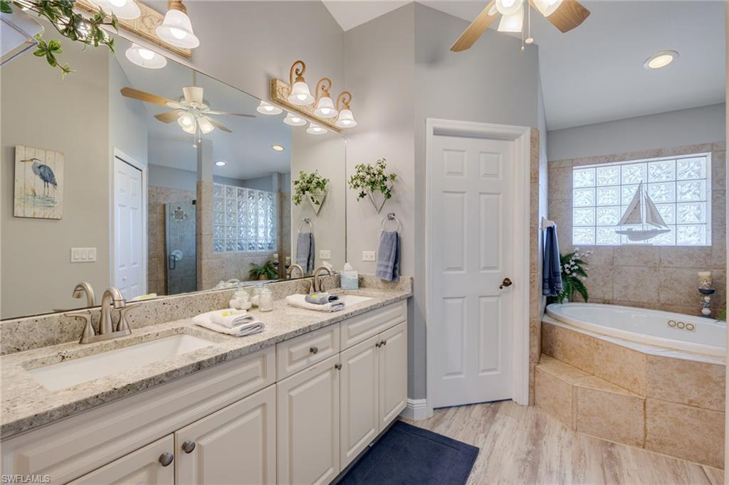 Double vanity with light-toned granite countertops and white cabinetry