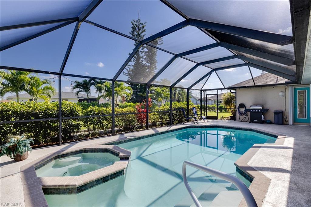 Screened lanai featuring a swimming pool and attached spa