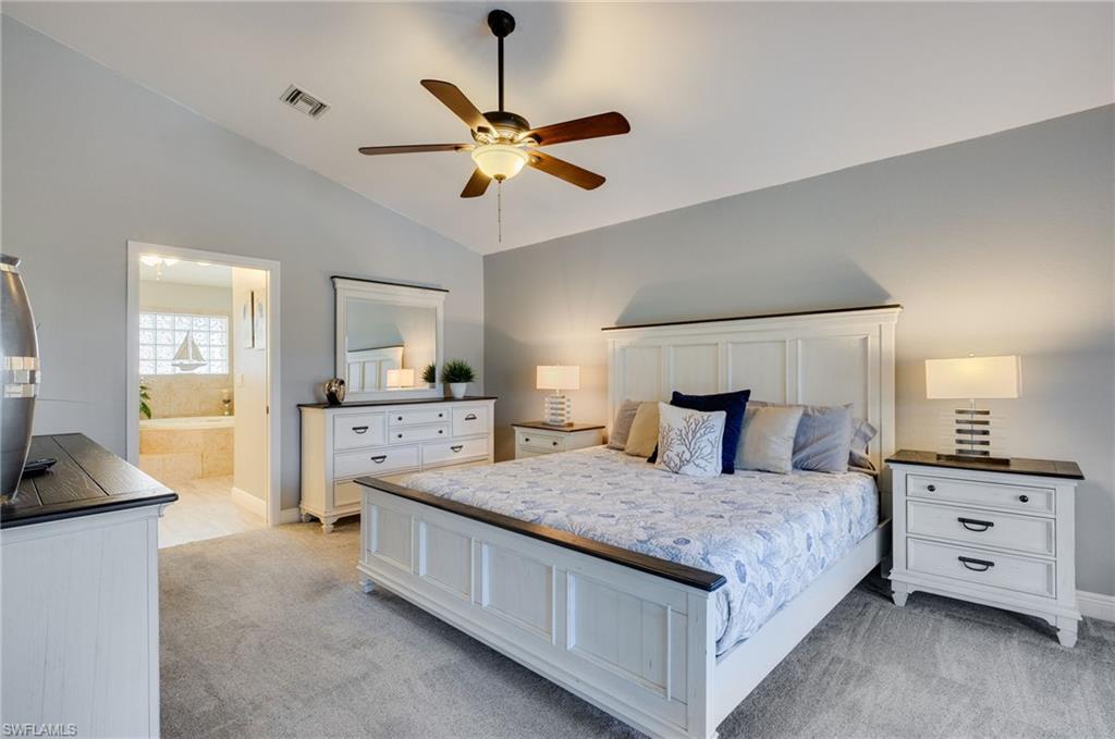 Spacious bedroom with vaulted ceilings and a ceiling fan