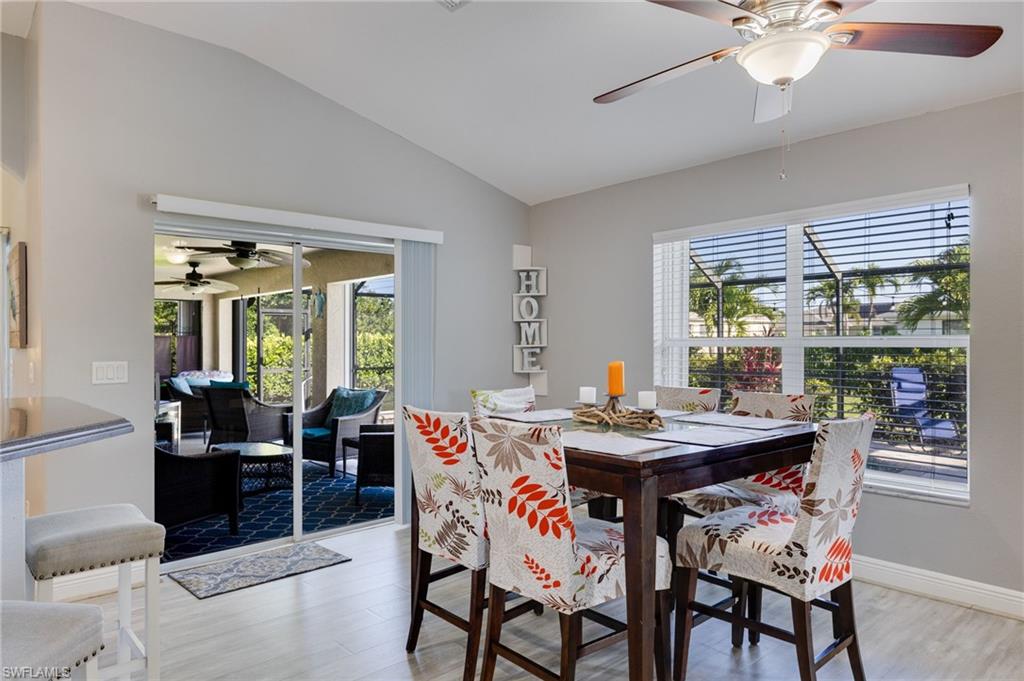 Dining area featuring vaulted ceilings and light wood-finish flooring
