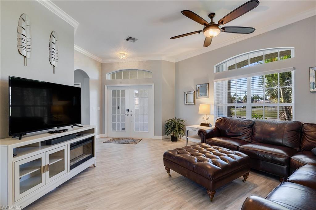 Spacious interior featuring light wood-finish flooring and crown molding