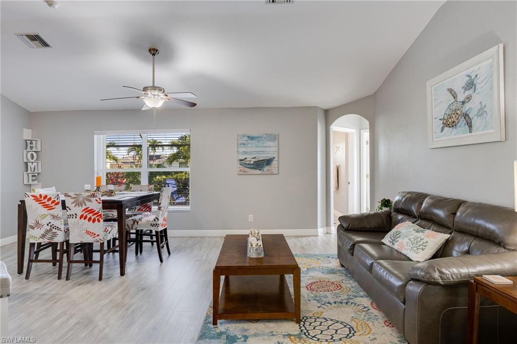 Open living area with light-toned wood-finish flooring