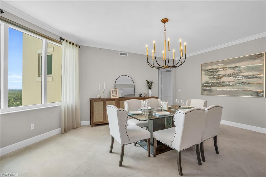 Dining area featuring a notable chandelier and ornamental molding