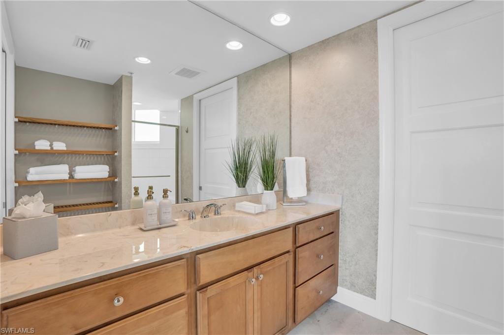 Bathroom with vanity and a shower