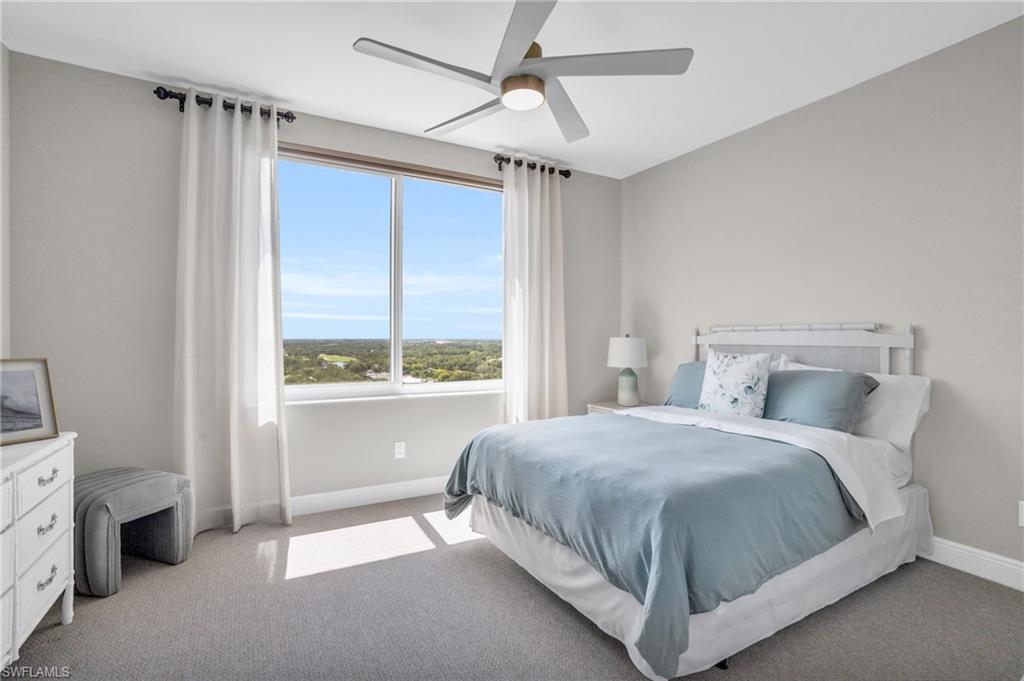 Bedroom featuring ceiling fan and carpet floors