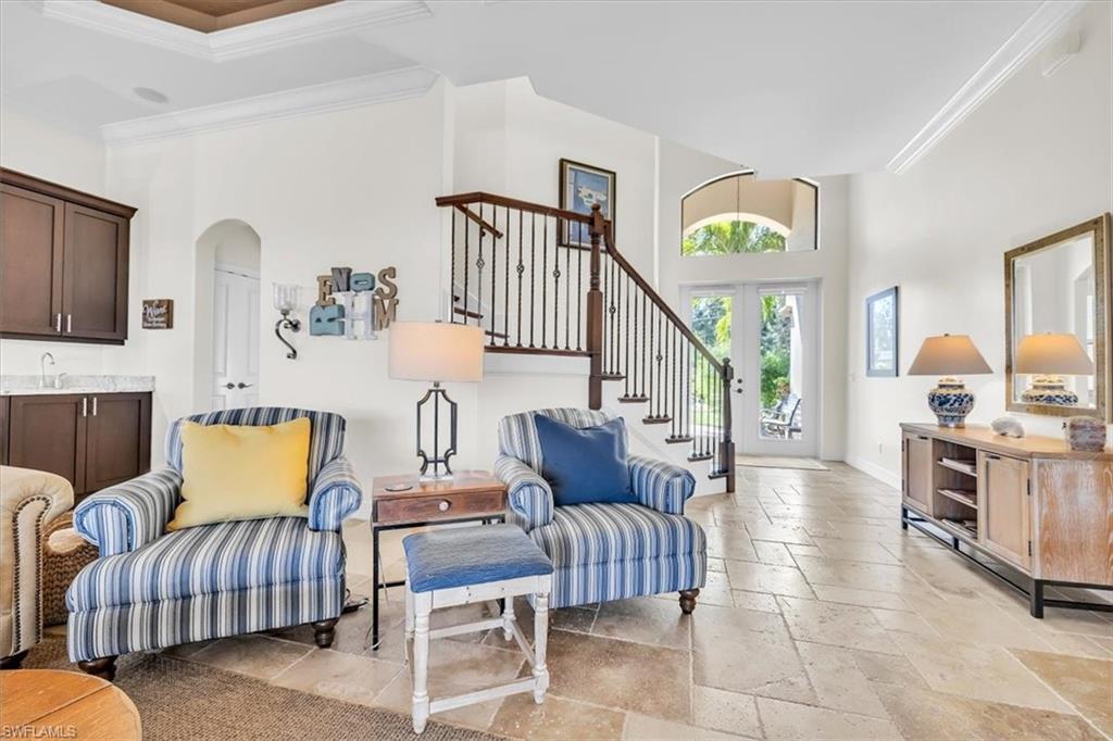 Grand foyer with double entry doors and an arched transom window