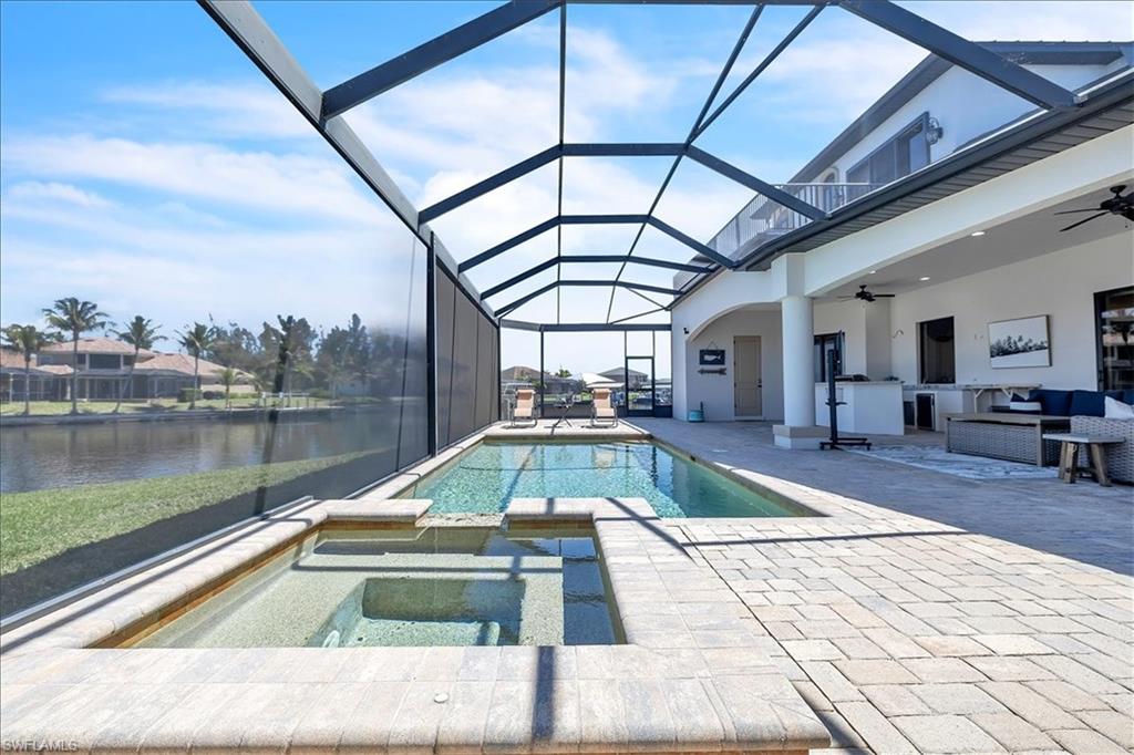 Screened lanai featuring a swimming pool and integrated spa