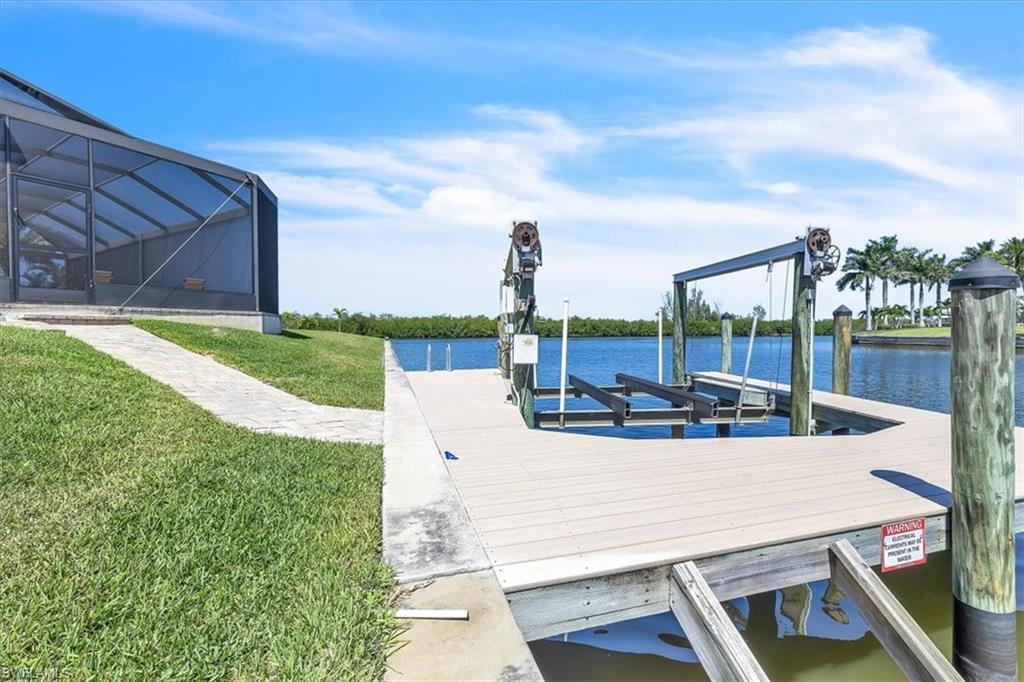 Waterfront dock with a boat lift, composite decking, and direct canal access