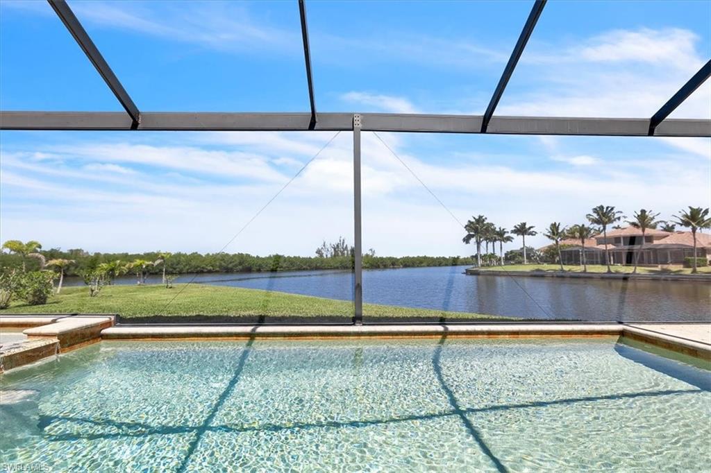 Screened lanai featuring a clear water pool, integrated spa, and tiled surround