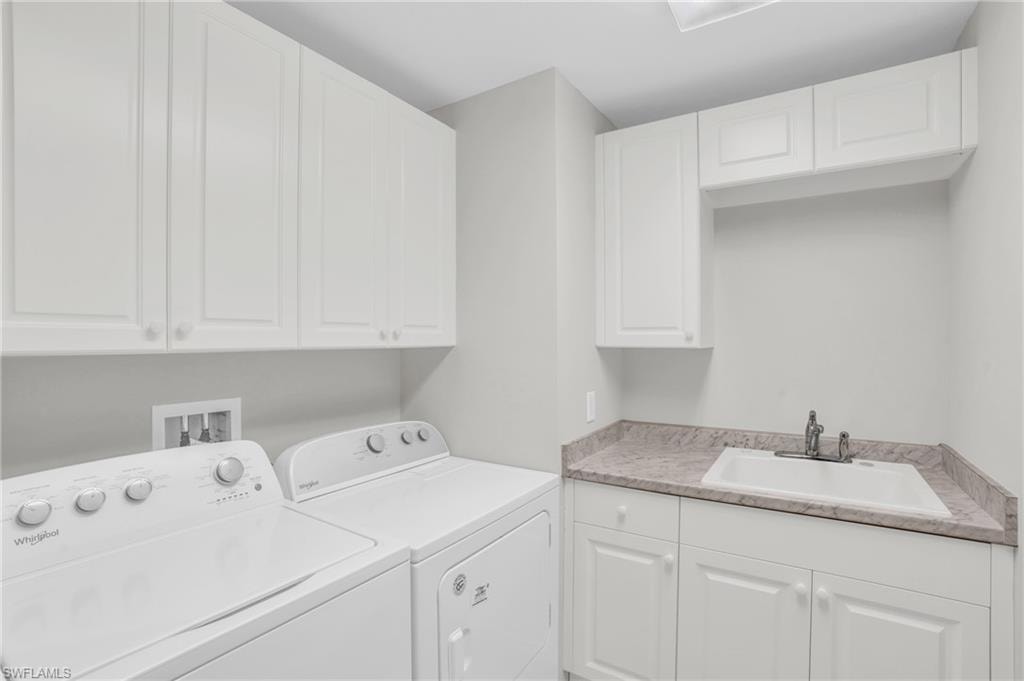 Laundry area featuring washing machine and clothes dryer and sink