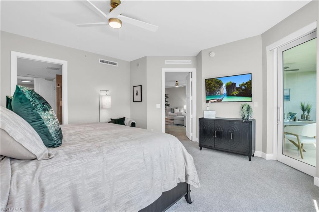 Bedroom with access to exterior, light carpet, and ceiling fan