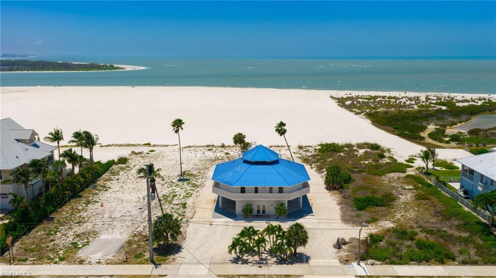 Octagonal coastal residence with a vibrant blue multi-tiered roof - Virtually Edited Image
