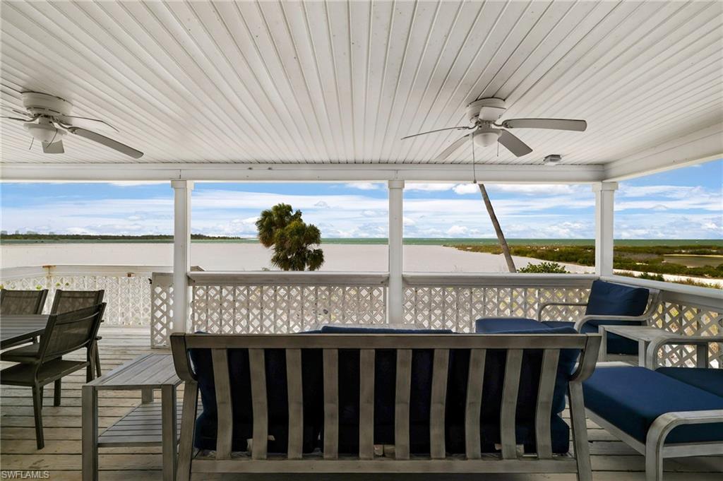 Expansive covered porch with beadboard ceiling and dual ceiling fans - Virtually Edited Image