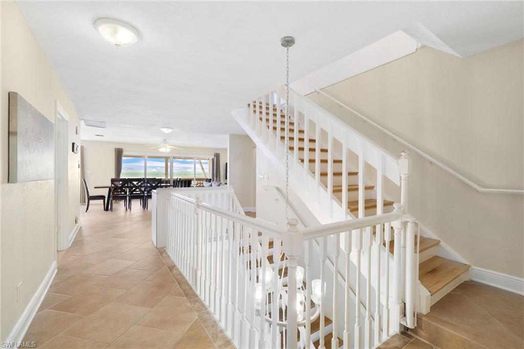 Hardwood staircase with white balusters and handrails - Virtually Edited Image