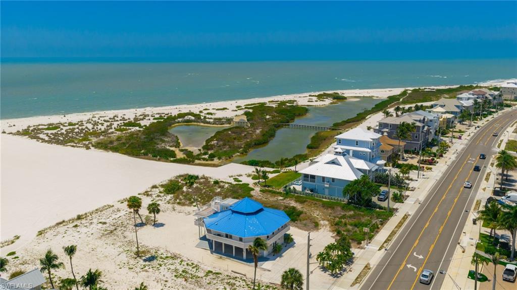 Expansive sandy shoreline with coastal vegetation bordering the water - Virtually Edited Image