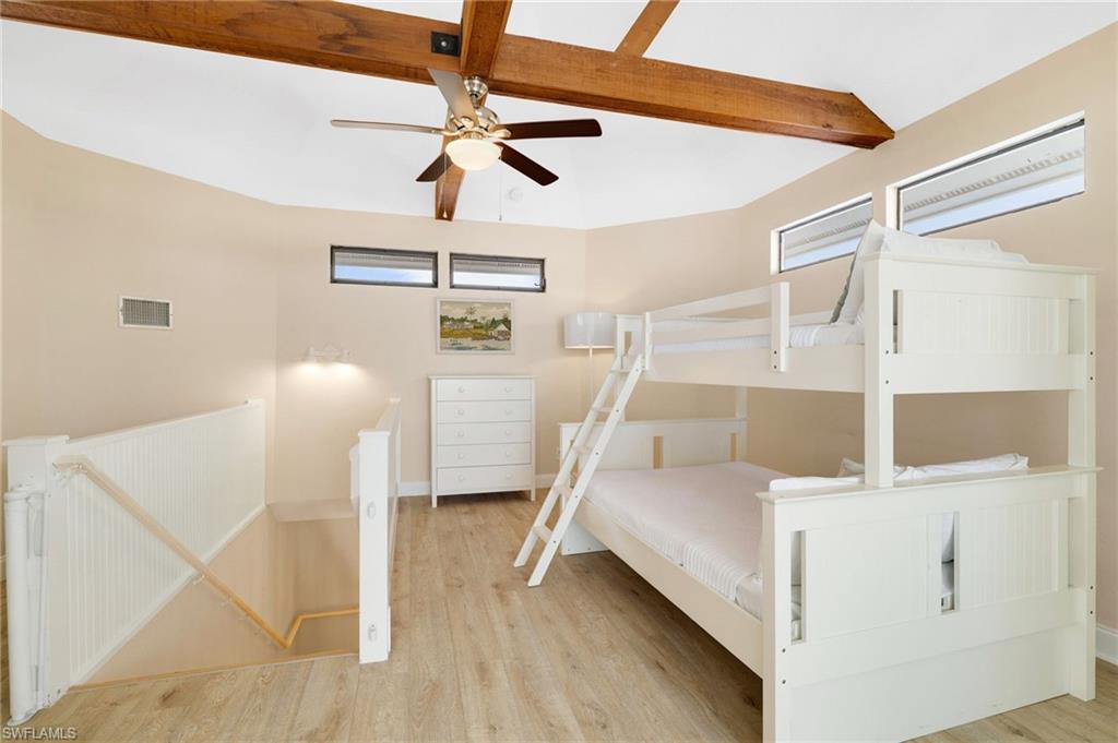Vaulted ceiling with exposed wood beams and ceiling fan - Virtually Edited Image