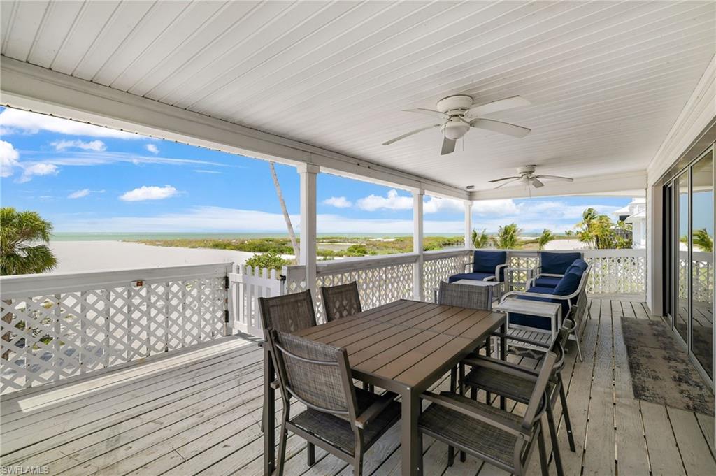 Covered outdoor deck with white painted wood flooring and ceiling - Virtually Edited Image