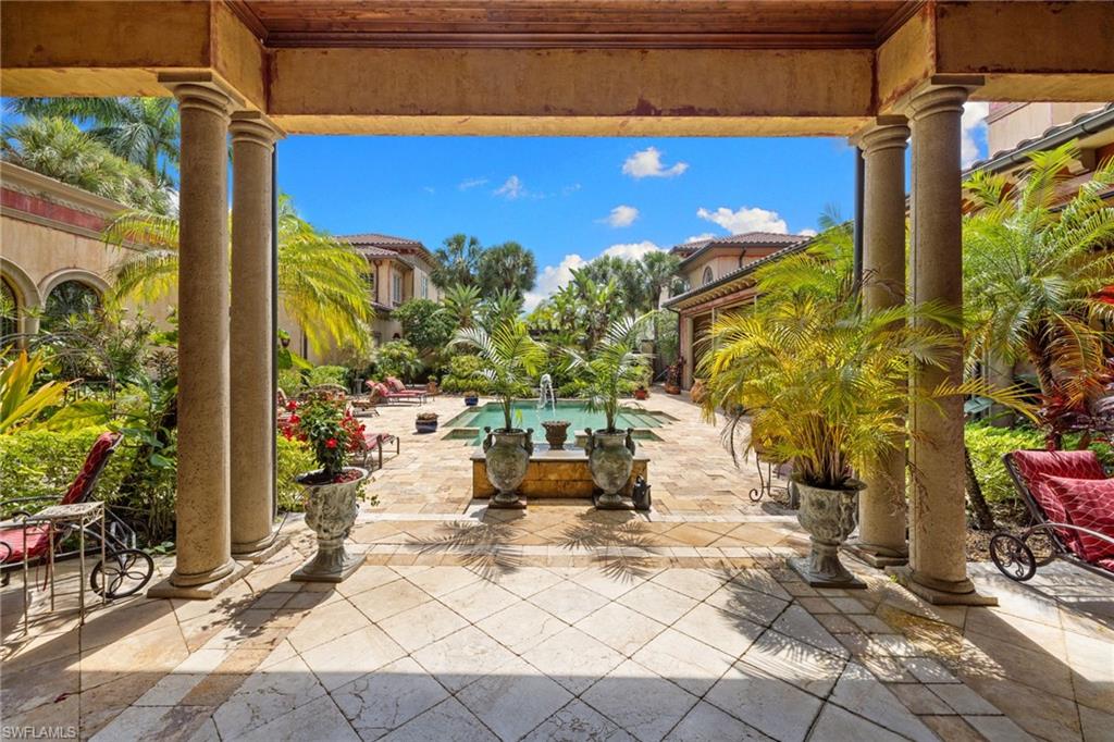 Courtyard with a central fountain and surrounding tropical landscaping