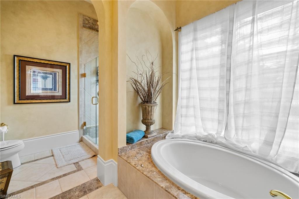 Soaking tub with a polished stone surround and expansive window