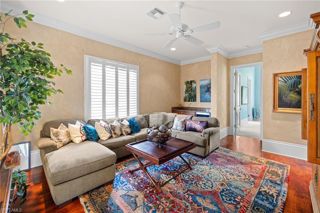 Spacious living area featuring wood-finish flooring and an expansive area rug