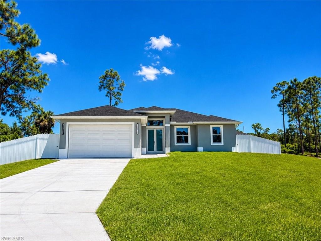 Contemporary single-story residence featuring a gray exterior, dark shingle roof, and white trim