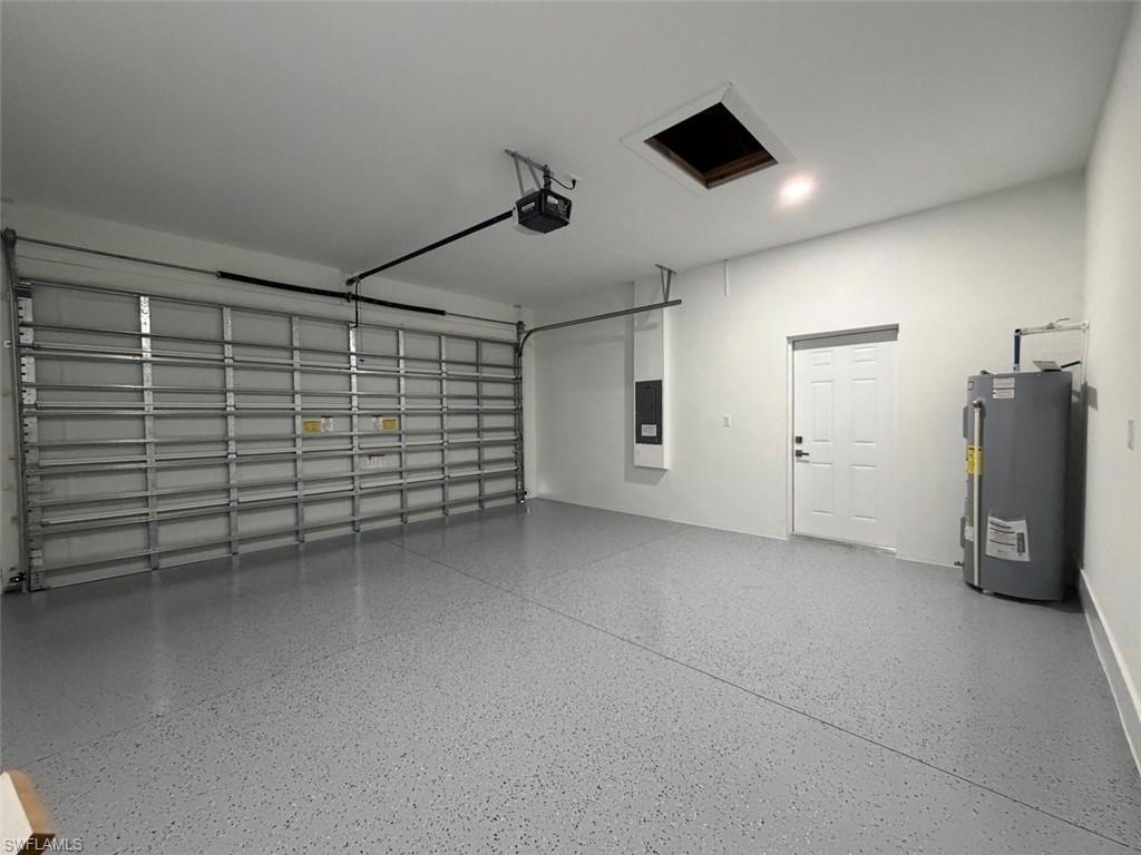 Spacious garage with an industrial-style overhead door and a speckled epoxy floor