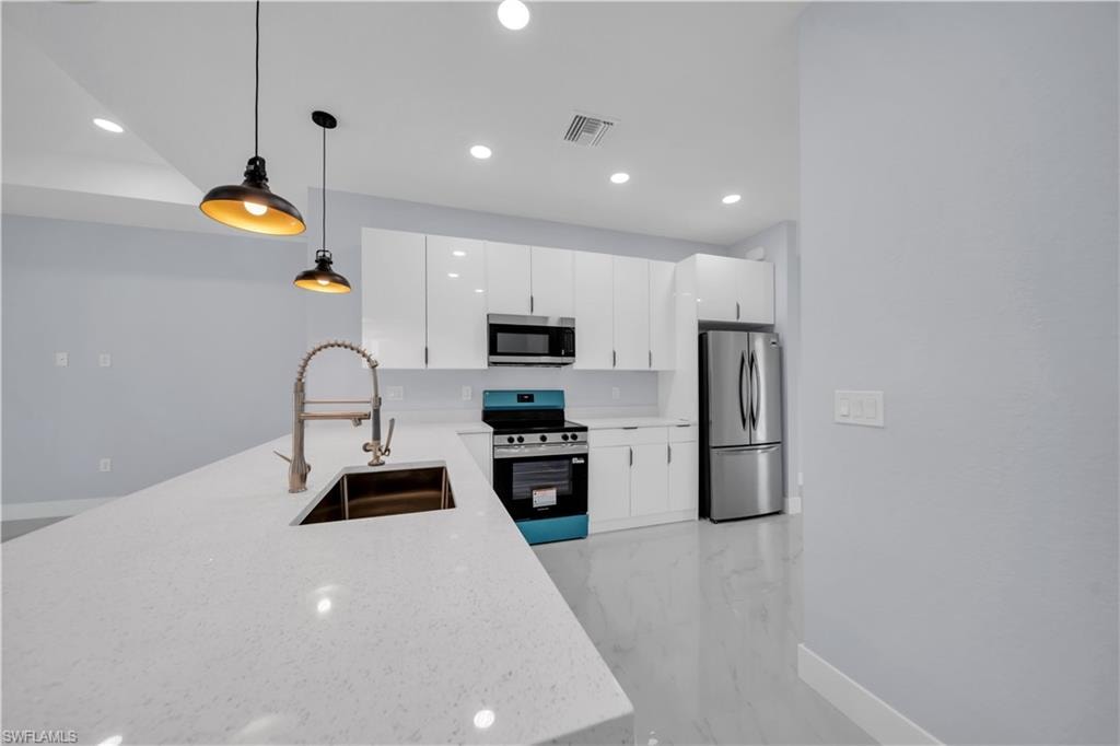Contemporary kitchen featuring a large island with an undermount sink and gooseneck faucet