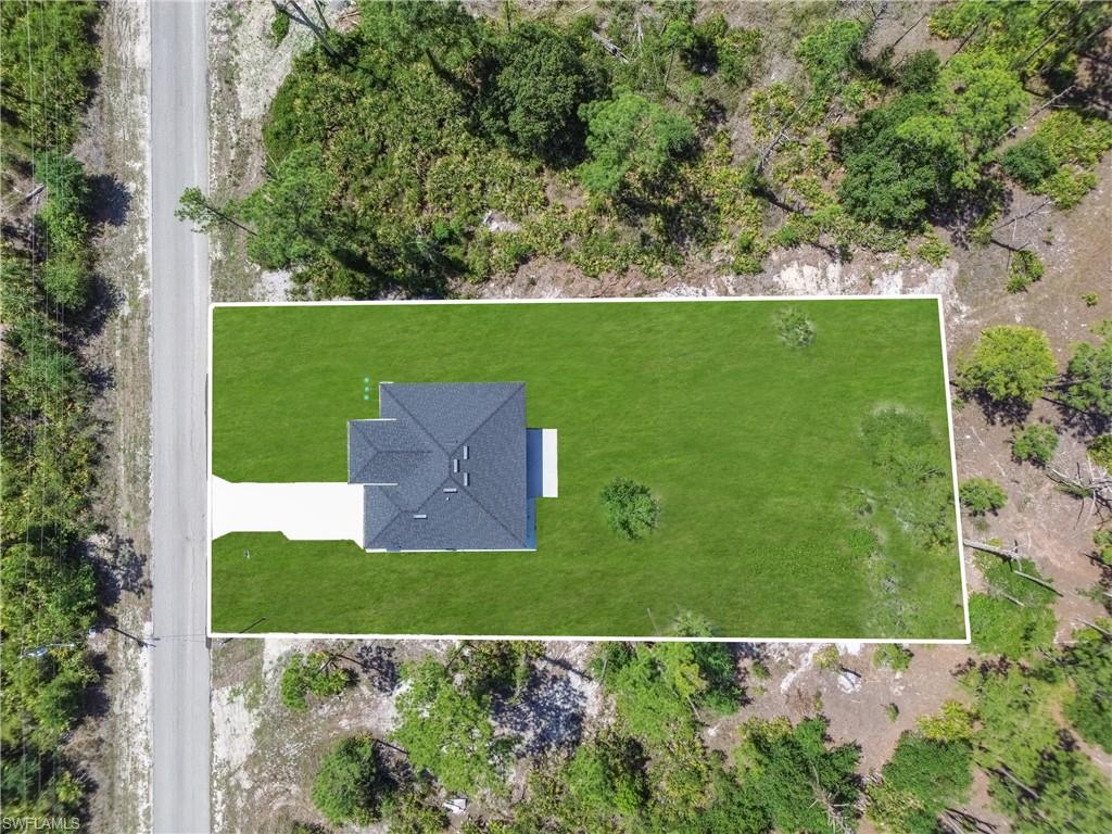 Expansive green lawn surrounds a single-story residence with a dark shingle roof