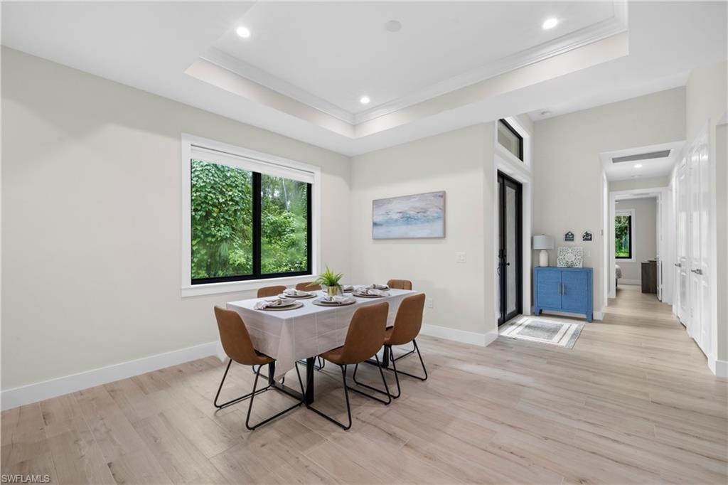 Dining area featuring a tray ceiling with recessed lighting