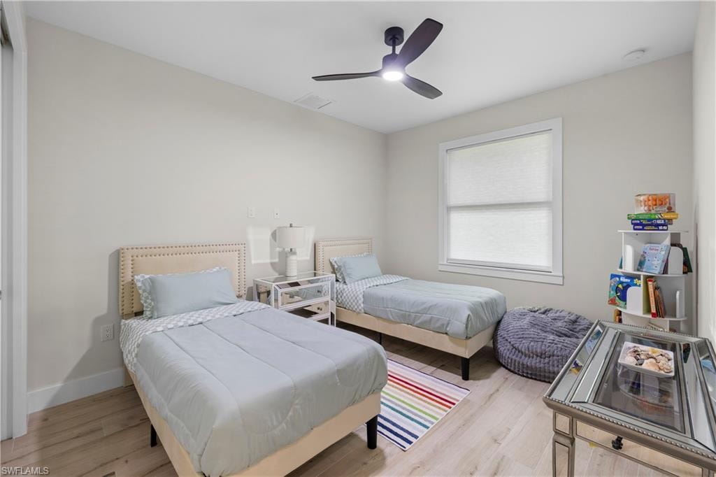 Light-filled room featuring light wood-finish flooring and neutral wall tones