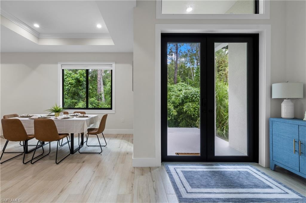 Double glass-paneled entry doors with transom window