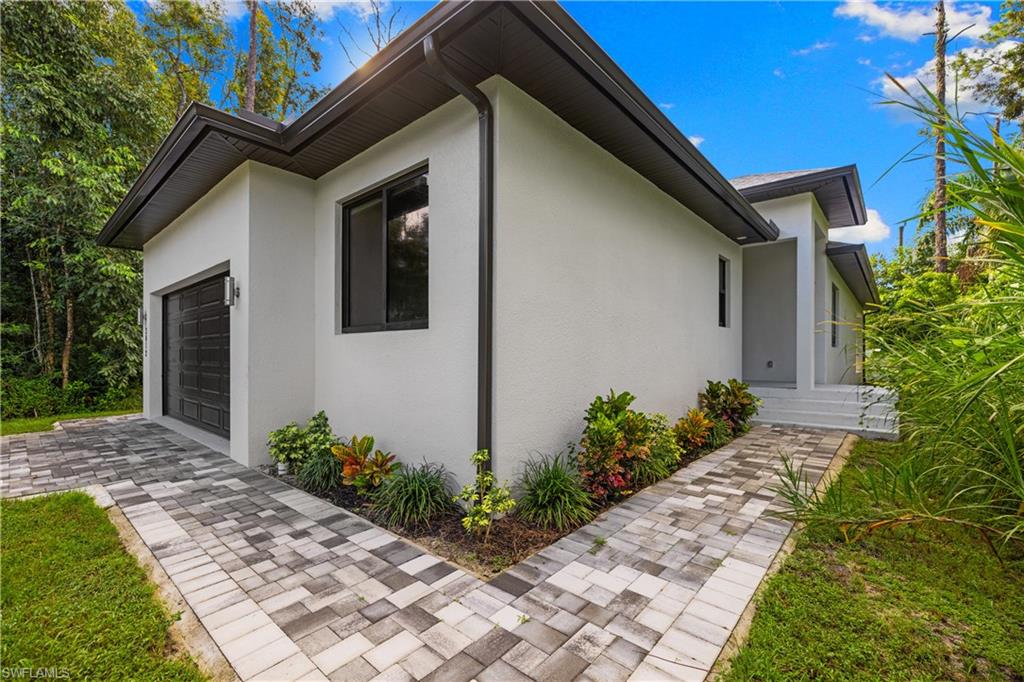 Contemporary exterior with a white stucco finish and dark trim