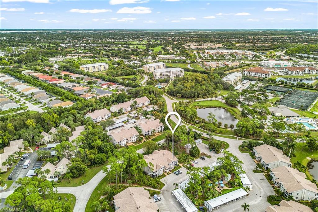 Aerial view of property and surrounding area with a nearby body of water and nearby suburban area