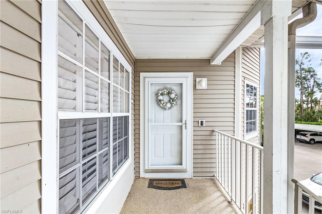 View of exterior entry featuring covered porch
