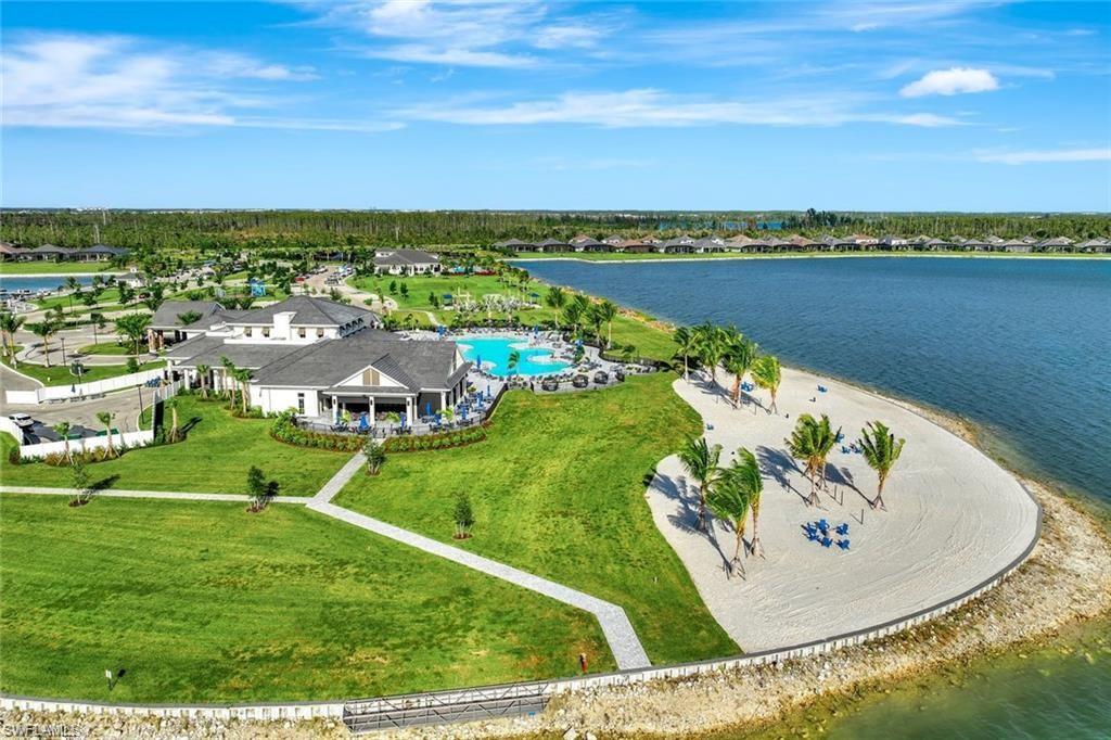 Aerial view of residential area with a large body of water and a pool