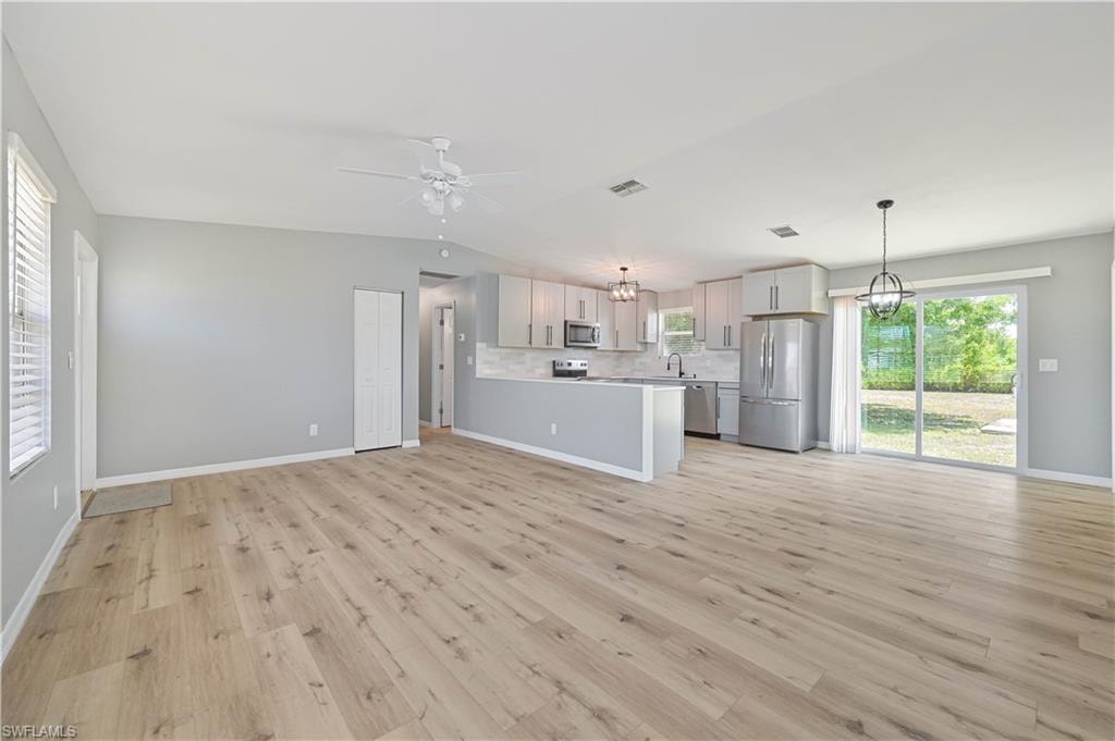Spacious interior featuring wood-finish flooring and light gray walls