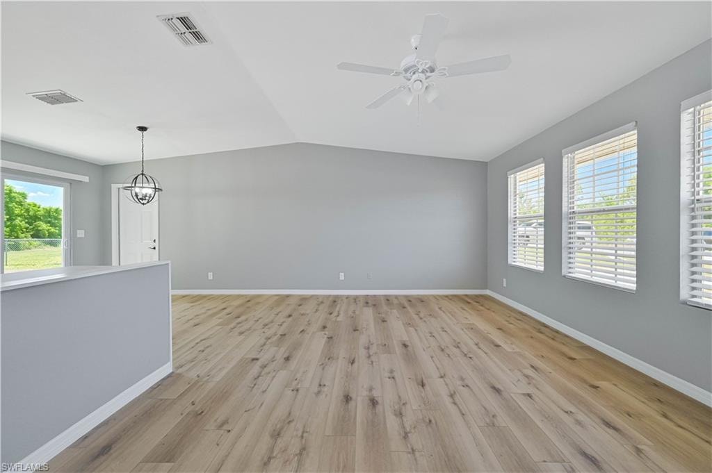 Spacious room with vaulted ceilings and wood-finish flooring