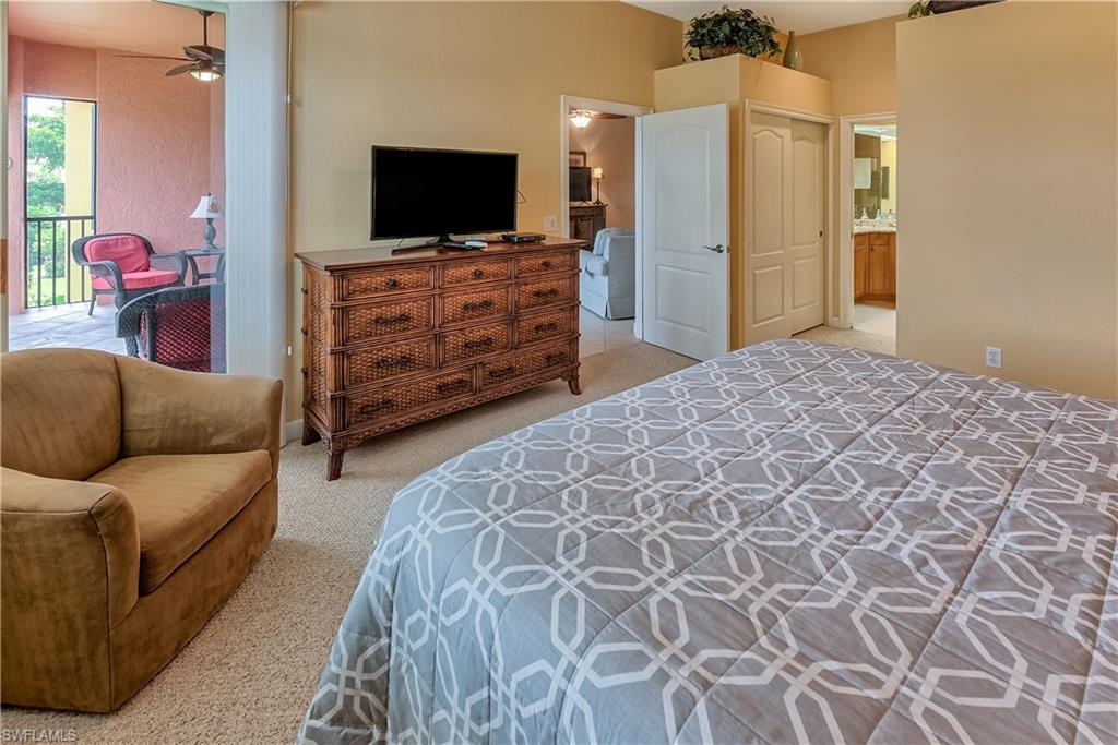 Bedroom featuring light carpet, access to exterior, and a closet