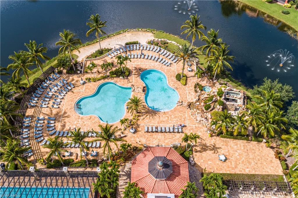 Bird's eye view of a nearby body of water and a pool