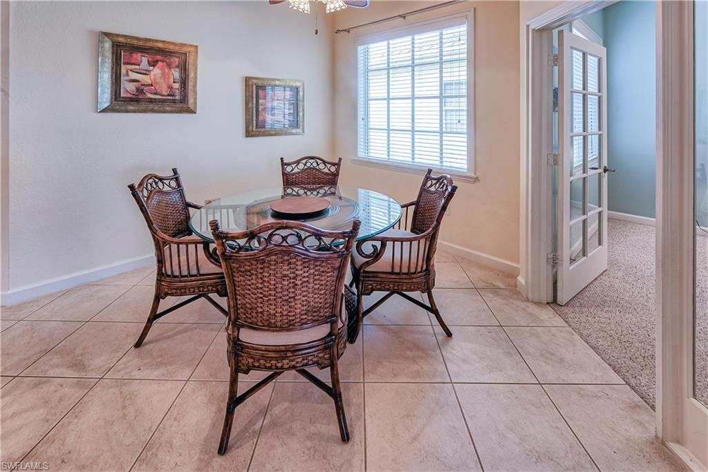 Dining space with baseboards and light tile patterned floors