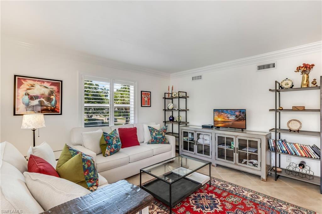 Tiled living room with crown molding