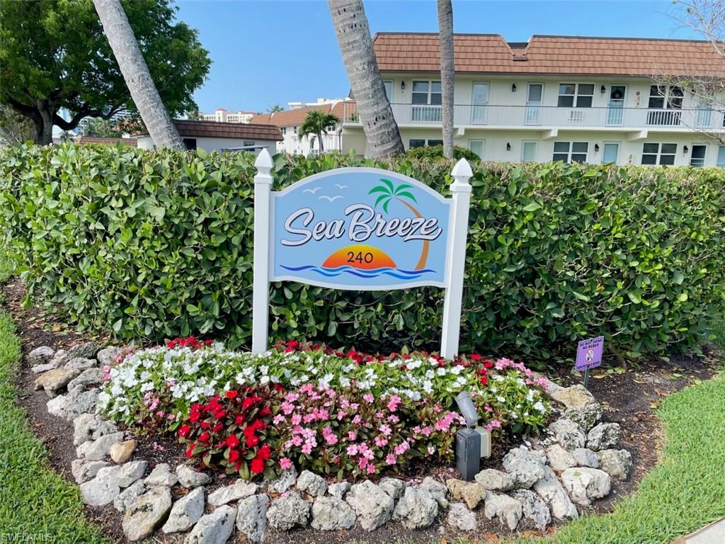 "Sea Breeze" signage with decorative landscaping, featuring a variety of colorful annuals and natural rock accents