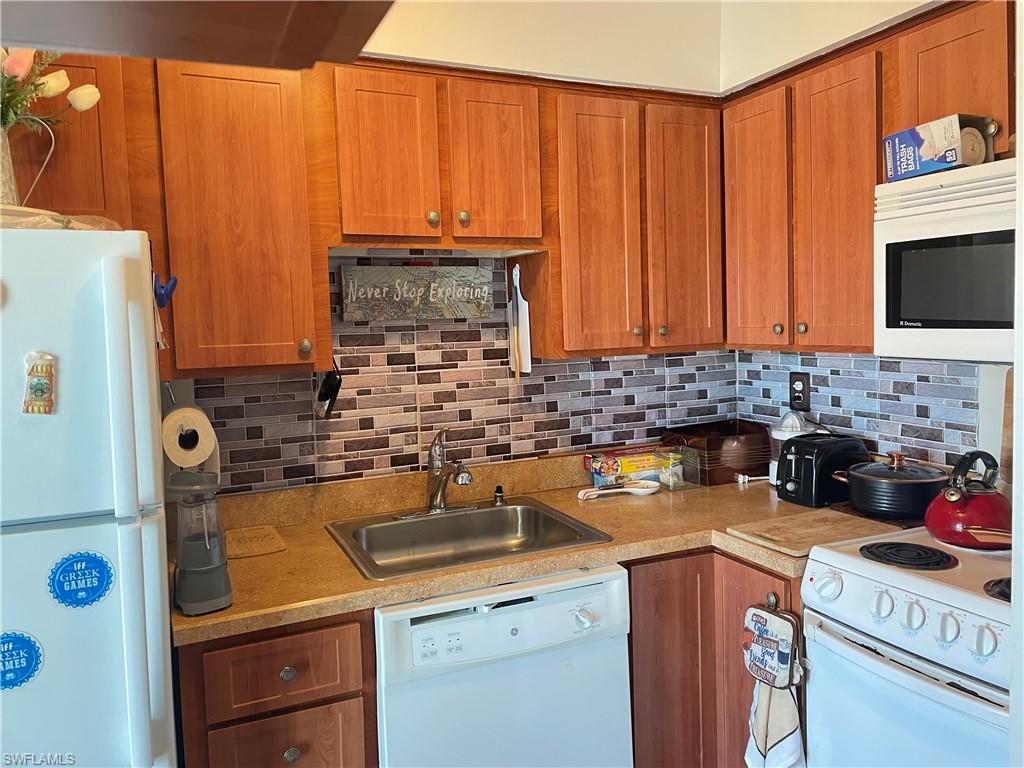 Wood-finish cabinetry paired with a mosaic tile backsplash